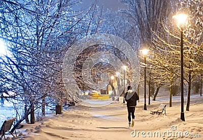Night running in the snowy park