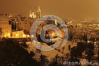 Night snowy Prague City with gothic Castle