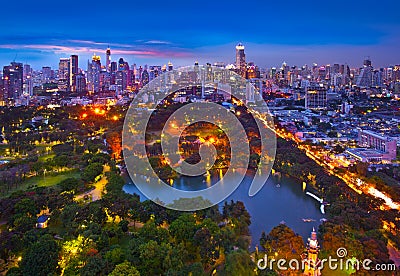 Night urban city skyline in a green environment, Suan Lum, Bangkok, Thailand.