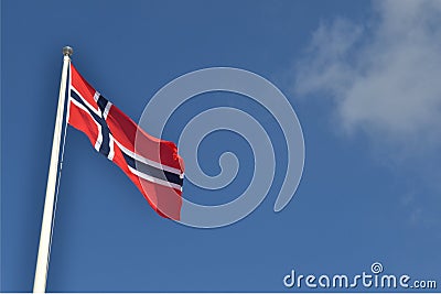Norwegian flag against blue sky