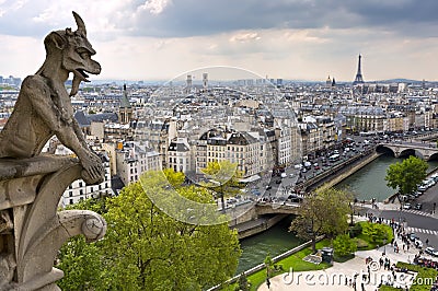 Notre Dame of Paris: Famous Chimera (demon) overlooking the Eiffel Tower at a spring day