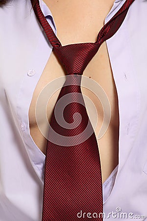 Nude female breast and red tie