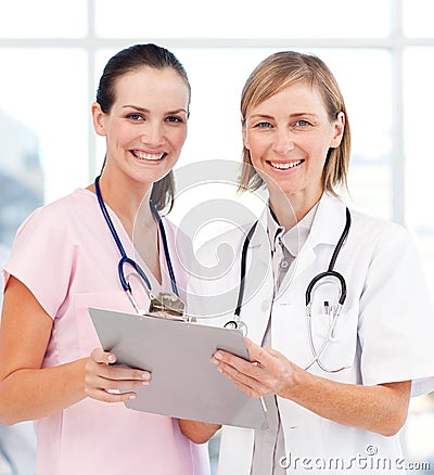 Nurse and doctor smiling at the camera