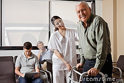 Nurse Helping Senior Patient With Walker