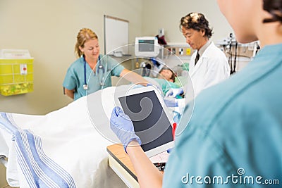 Nurse Holding Digital Tablet While Doctor And