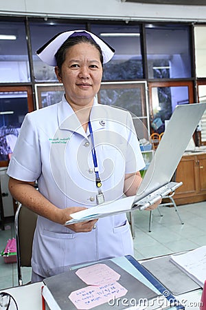 Nurse holding patient profile chart on ward