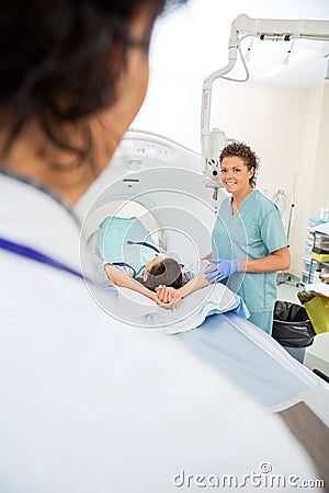 Nurse Preparing Patient For CT Scan
