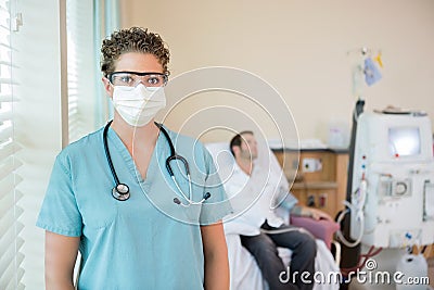 Nurse In Protective Clothing While Patient