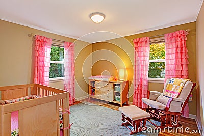 Nursery room with pink ruffle curtains