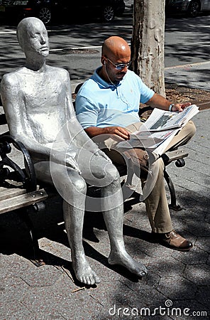 NYC: Man Reading Newspaper & Sculpture