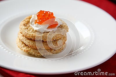 Oat bran cookies with red caviar and cream cheese