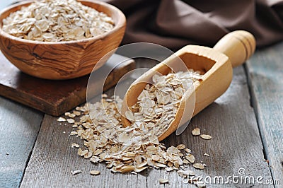 Oat flakes in wooden scoop