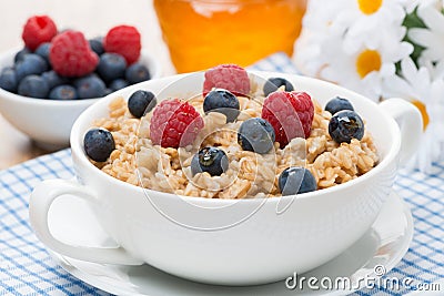 Oat porridge with berries, close-up