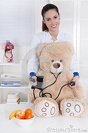 Occupation: Young female doctor with a teddy bear.