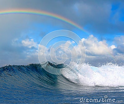 Ocean wave in tropical paradise and rainbow