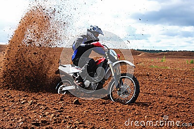 Off-road motorbike driving in dirt.