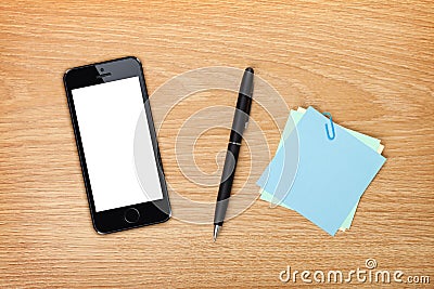 Office table with mobile phone and supplies