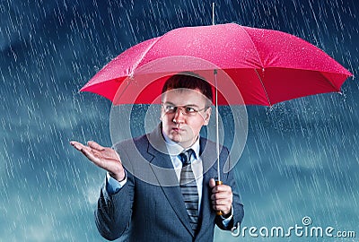 Office worker hiding under an umbrella