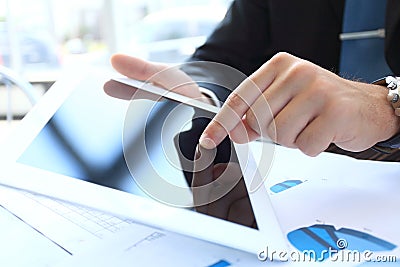 Office worker using a touchpad to analyze data