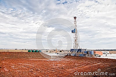 Oil Drilling Rig and Empty Mud Pond