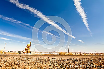 Oil pump at desert with sunny sky