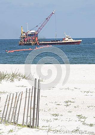 Oil spill workers at seashore