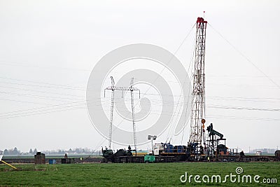 Oilfield with workers and oil drilling rig