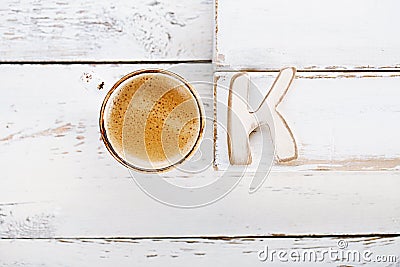 OK sign with espresso coffee in cup and K letter