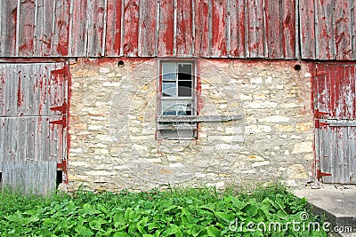 Old Abandoned Barn with Broken Window and Two Wood Doors