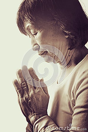 Old asian buddhist woman praying
