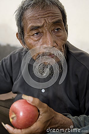 Old asian man with apple