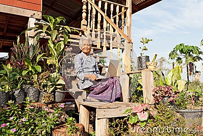 Old asian woman with laptop