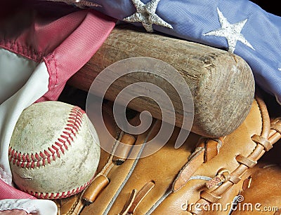 Old baseball bat, mitt, ball and flag.