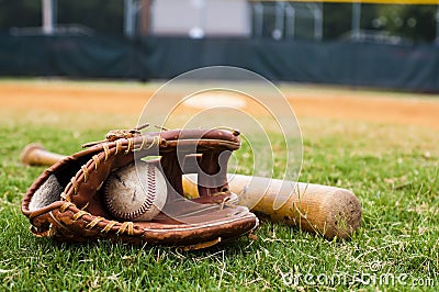 Old Baseball, Glove, and Bat on Field