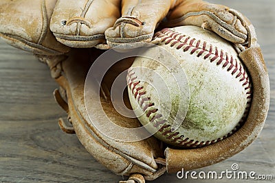 Old Baseball and Glove on Faded Wood