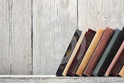 Old book shelf blank spines, empty binding stand on wood texture