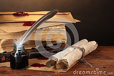 Old books, scrolls, feather pen and inkwell