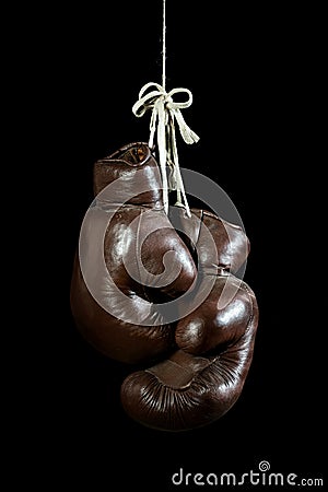 Old Boxing Gloves, hanging, on black Background