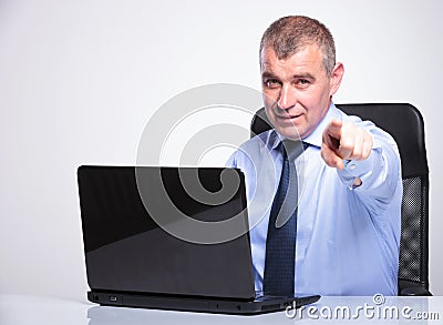 Old business man points at you from laptop