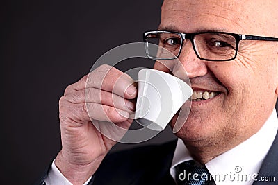Old businessman with a cup of coffee
