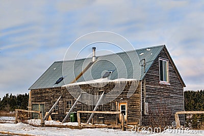 Old barn in canada with beams holding walls.