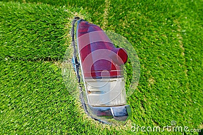 Old car rear lights with artificial grass around