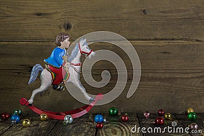 Old christmas decoration of tin: rocking horse on wooden backgro