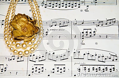 Old classical music notes with vintage pearls
