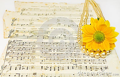 Old classical music scores with pearls and flower