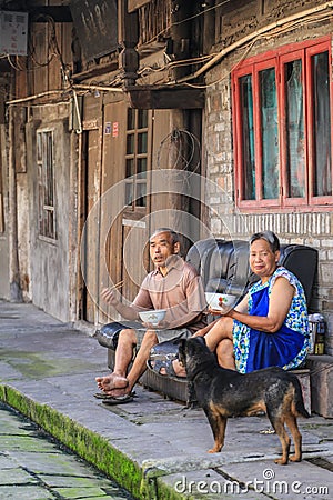 Old couple eating in luoba town,sichuan,china