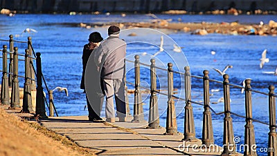 Old couple feeding the birds