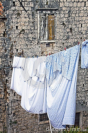 Old Dalmatian house with fresh laundry hanging on a cloth line