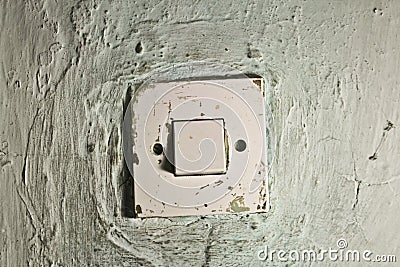 Old dirty light switch on old cracked wall