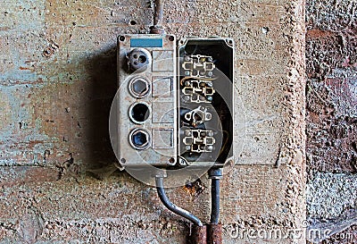 Old electrical panel on concrete wall